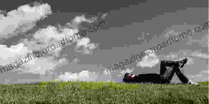 A Person Sitting In A Field, Looking Up At The Sky Overcoming The Fear Of Death: Through Each Of The 4 Main Belief Systems